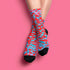 Dive into bold fashion with these vibrant socks featuring an eye-catching red, blue, and pink cheetah print pattern. Perfect for those who love to make a statement, these socks are ideal for brightening up any outfit and showcasing your unique style. Comfortable and stylish with black heels and toes, they are a must-have accessory for the fashion-forward.