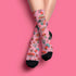 Cute mushroom-themed pink socks with various fungi and nature illustrations, black heels and toes, ideal for casual wear or gifting