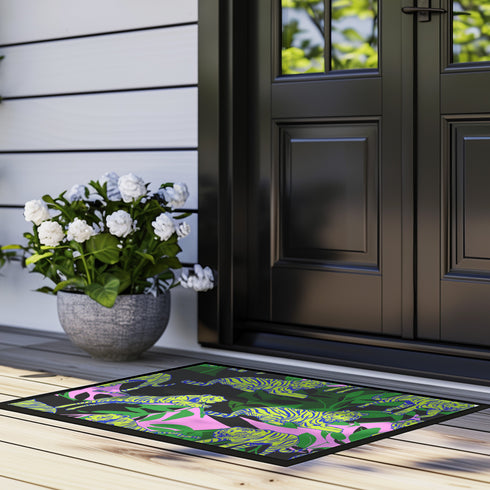 Vibrant doormat featuring stylized yellow tigers with blue stripes amidst green foliage and pink accents on a black background. Bold, maximalist design for indoor/outdoor use.