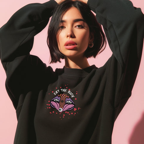 a black sweatshirt featuring a psychedelic "Eat the Rich" design with an eyeball and vampire teeth,