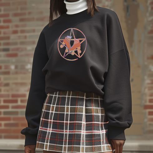 Black sweatshirt featuring a colorful pentagram design with a roller skate in the center, surrounded by dried flowers and set on a textured background.