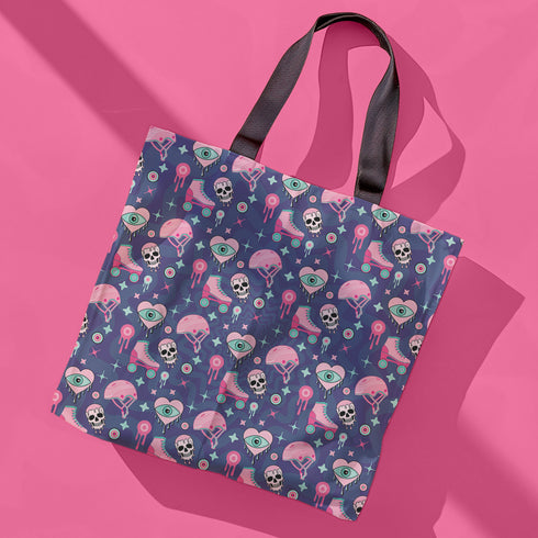Tote bag with black handles and a purple background featuring a repeating pattern of pink roller skates, white skulls, pink helmets, teal eyeballs, and pink jellyfish-like shapes. The design has a spooky yet playful vibe, combining roller derby elements with supernatural motifs. The overall aesthetic is quirky, retro-inspired, and perfect for skate enthusiasts with a taste for the unconventional.