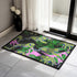 Vibrant doormat featuring stylized yellow tigers with blue stripes amidst green foliage and pink accents on a black background. Bold, maximalist design for indoor/outdoor use.