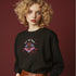 a black sweatshirt featuring a psychedelic "Eat the Rich" design with an eyeball and vampire teeth,