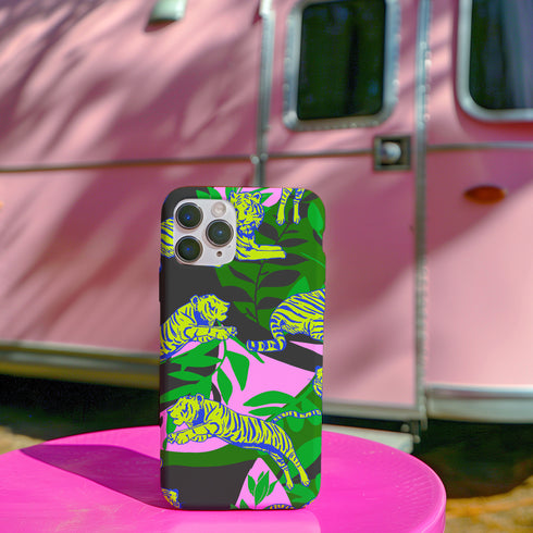 Colorful maximalist phone case with electric yellow tigers prowling through lush green tropical foliage. Psychedelic jungle theme on a purple backdrop. Bold summer design.