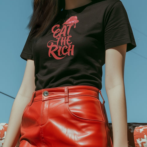 Black t-shirt with vibrant multicolored patterned raised fist graphic and blue "RESIST" text underneath. Rainbow activist protest shirt with psychedelic design elements on cotton-polyester blend.
