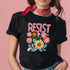 Black unisex t-shirt with "Resist" in bold, embroidered-style floral print. Political activism shirt with a vintage, handcrafted feel.