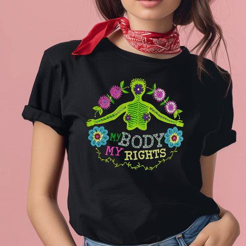 Black unisex t-shirt featuring "MY BODY MY RIGHTS" text with vibrant embroidery-style design of green skeleton figure and colorful flowers. Feminist pro-choice shirt with neon pink, blue, and yellow details available in sizes S-3XL in cotton-poly blend.