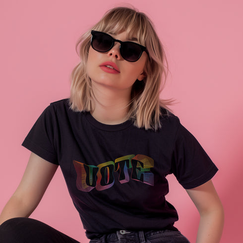 Election 2024 t-shirt with "VOTE" printed in large, colorful letters. Each letter features a different color from the rainbow spectrum, styled in a groovy 70s-inspired font.