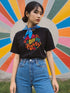 Black unisex t-shirt featuring vibrant "HANDS OFF MY RIGHTS" text design in multi-colored 3D-effect lettering. The words appear in red, yellow, teal, and pink with playful dots scattered around the text. The design has a vintage-inspired embroidery look on a soft cotton-polyester blend fabric. Available in Black and Heather Black options, sizes S-3XL, with a classic crew neck and short sleeves. Perfect for activism, protests, and making bold statements.