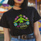 Black unisex t-shirt featuring "MY BODY MY RIGHTS" text with vibrant embroidery-style design of green skeleton figure and colorful flowers. Feminist pro-choice shirt with neon pink, blue, and yellow details available in sizes S-3XL in cotton-poly blend.