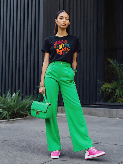Black unisex t-shirt featuring vibrant "HANDS OFF MY RIGHTS" text design in multi-colored 3D-effect lettering. The words appear in red, yellow, teal, and pink with playful dots scattered around the text. The design has a vintage-inspired embroidery look on a soft cotton-polyester blend fabric. Available in Black and Heather Black options, sizes S-3XL, with a classic crew neck and short sleeves. Perfect for activism, protests, and making bold statements.