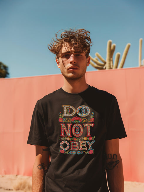 Black T-shirt with bold, embroidered-style text reading "Do Not Obey" surrounded by floral patterns.