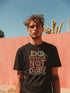 Black T-shirt with bold, embroidered-style text reading "Do Not Obey" surrounded by floral patterns.