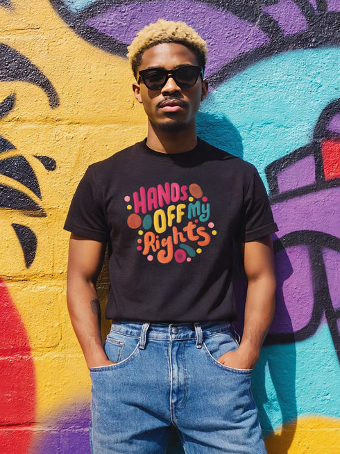 Black unisex t-shirt featuring vibrant "HANDS OFF MY RIGHTS" text design in multi-colored 3D-effect lettering. The words appear in red, yellow, teal, and pink with playful dots scattered around the text. The design has a vintage-inspired embroidery look on a soft cotton-polyester blend fabric. Available in Black and Heather Black options, sizes S-3XL, with a classic crew neck and short sleeves. Perfect for activism, protests, and making bold statements.