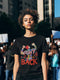 Black T-shirt with a bold "Fight Back" design featuring a woman raising her fists, surrounded by colorful floral details.