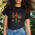 Black unisex t-shirt with "MY BODY MY RIGHTS" design featuring neon green female figure filled with vibrant pink and red flowers. Feminist pro-choice shirt with colorful text, available in cotton-poly blend, sizes S-3XL.