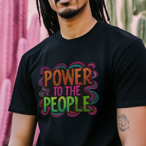Black unisex t-shirt with colorful "POWER TO THE PEOPLE" text design in orange, pink, and green lettering surrounded by swirling psychedelic rainbow border.