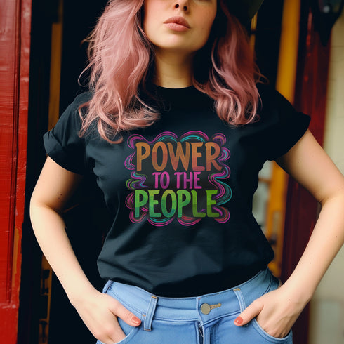 Black unisex t-shirt with colorful "POWER TO THE PEOPLE" text design in orange, pink, and green lettering surrounded by swirling psychedelic rainbow border.