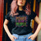 Black unisex t-shirt with colorful "POWER TO THE PEOPLE" text design in orange, pink, and green lettering surrounded by swirling psychedelic rainbow border.