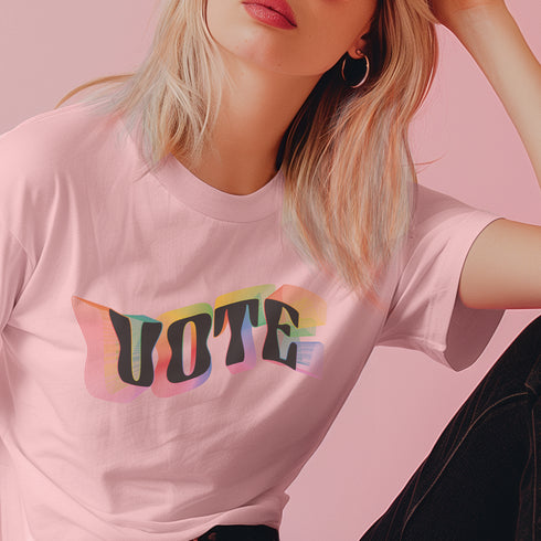 Election 2024 t-shirt with "VOTE" printed in large, colorful letters. Each letter features a different color from the rainbow spectrum, styled in a groovy 70s-inspired font.