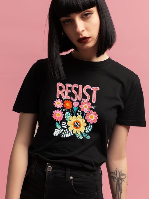 Black unisex t-shirt with "Resist" in bold, embroidered-style floral print. Political activism shirt with a vintage, handcrafted feel.