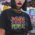 Black unisex t-shirt with colorful "POWER TO THE PEOPLE" text design in orange, pink, and green lettering surrounded by swirling psychedelic rainbow border.
