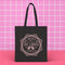 Election 2024 Canvas tote bag featuring a circular design with two cats and text "The Society of Childless Cat Ladies Against Couch Fuckers" in burgundy on a natural or black.