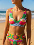 Colorful high waisted bikini set with bold floral and checkerboard print featuring pink, red, yellow, green, blue, and white tones. Scoop neck bikini top with wide straps and matching high rise bottoms with structured waistband. Smooth stretch swim fabric with symmetrical floral motifs and graphic checker pattern. Bright, retro-inspired design with vibrant color blocking and modern sporty silhouette.