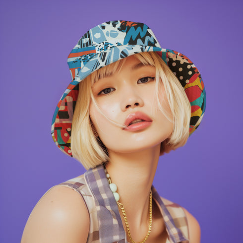 A reversible 90s-inspired bucket hat with two maximalist designs. One side showcases a colorful collage of polka dots and abstract patchwork shapes in vibrant reds, yellows, greens, and blues, evoking a playful retro feel. The opposite side features a contrasting blue-toned leopard print with geometric accents, adding an edgy streetwear flair. The hat has a soft linen-textured polyester fabric that’s lightweight, moisture-wicking, and breathable.