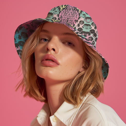 Reversible bucket hat with colorful snakeskin print in pastel shades of pink, blue, and yellow