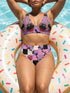 Two piece pastel goth bikini with a v neck top and high waisted bottom. The purple top is covered in large black cherries dripping red, tiny flying bats, and white sparkle stars. The high cut bottoms show a pink, lavender, black, and cream checkerboard overlaid with black thorny vines and dripping red hearts. Soft, stretchy recycled polyester fabric with UPF 50 sun protection and removable padding. Creepy cute whimsigoth swimwear for spooky summer pool days, haunted beach trips, and music festivals.