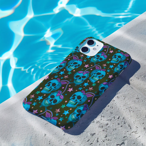 Black phone case featuring bright electric blue skulls with purple cherry stems and colorful stars scattered throughout the pattern. Gothic yet playful design.