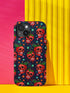 Phone case featuring vibrant red apple skulls with green stems and multicolored stars on navy background. Gothic alternative design with bright colorful accents.