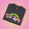 An election 2024 t-shirt with a colorful retro-style graphic that reads "Childless Cat Lady" across the chest. The text is in a playful, curvy font with each word in a different color - "Childless" in yellow-green, "Cat" in pink, and "Lady" in purple. Small cat face icons are incorporated into the letters 'a' in "Cat" and "Lady".
