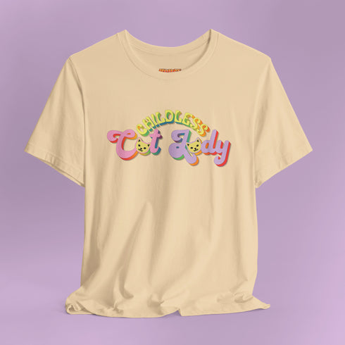 An election 2024 t-shirt with a colorful retro-style graphic that reads "Childless Cat Lady" across the chest. The text is in a playful, curvy font with each word in a different color - "Childless" in yellow-green, "Cat" in pink, and "Lady" in purple. Small cat face icons are incorporated into the letters 'a' in "Cat" and "Lady".