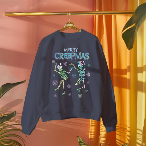 A dark green holiday sweatshirt featuring two dancing skeletons wearing Santa hats. The text "Merry Creepmas" is displayed above them in icy, drippy font. The design is surrounded by colorful snowflakes, blending spooky and festive elements for a fun, alternative holiday look.