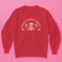 Christmas sweatshirt with "SEASONS SCREAMINGS, DARKLING" text arched over a skull wearing Santa hat. Bats, flowers, and ornate designs surround the skull in vintage-inspired style.