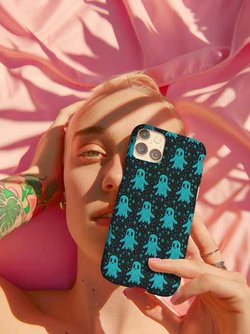 Black phone case featuring bright teal textured ghost pattern with matching star accents. Kawaii-style ghosts with simple black eyes on dark background.