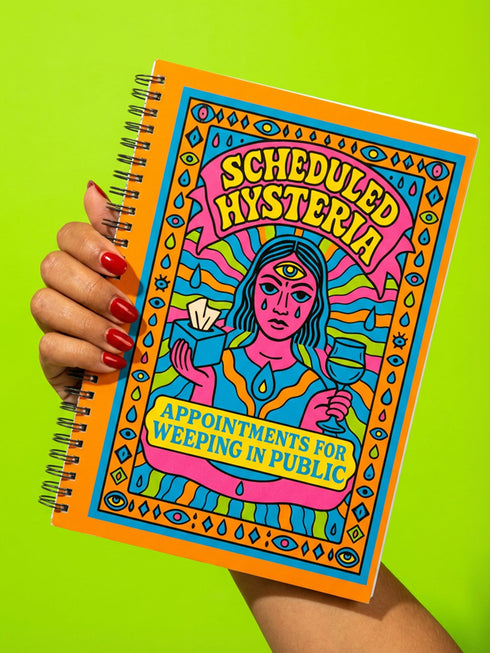 Undated weekly planner with hardcover and metal wire-o spiral binding options in black or gold. Cover features retro pop art illustration of a three-eyed woman crying while holding wine and tissues, with text Scheduled Hysteria. Vibrant orange background with psychedelic blue and purple patterns. Open planner shows flexible weekly layout on high-quality 60lb paper. Lays flat for easy writing. Ideal for ADHD organization, funny mental health gifts, and maximalist desk decor. Satin matte finish.