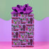 Vibrant purple wrapping paper with gothic-inspired design for 50th birthdays. Features colorful skulls wearing party hats, coffins, 'RIP 40s' tombstones, and 'Youth Dies Here' text. Perfect for edgy, humorous gifts to 50-year-olds.