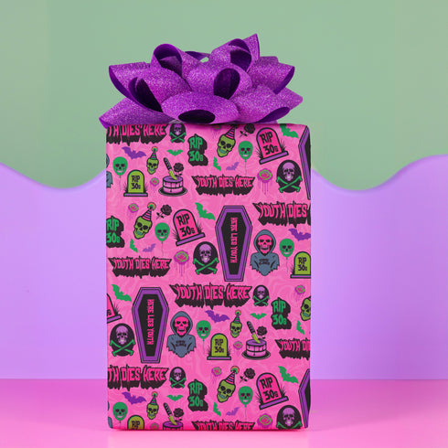 40th birthday Vibrant wrapping paper featuring a playful goth theme with illustrations of skulls, birthday cakes, and caskets marked "RIP 30s", set against a pink background with green accents. Ideal for themed 40th birthday gifts.