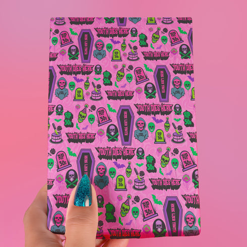 40th birthday Vibrant wrapping paper featuring a playful goth theme with illustrations of skulls, birthday cakes, and caskets marked "RIP 30s", set against a pink background with green accents. Ideal for themed 40th birthday gifts.