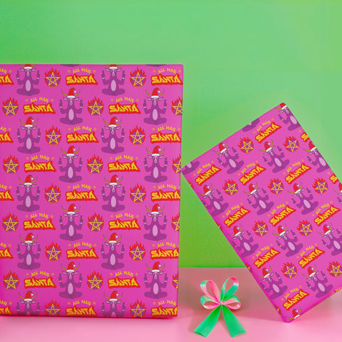 Vibrant pink wrapping paper featuring Occult symbol Baphomet Santas throwing horns, surrounded by flaming pentagrams and "All Hail Santa" text. A punk rock twist on Christmas gift wrap.