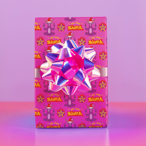 Vibrant pink wrapping paper featuring Occult symbol Baphomet Santas throwing horns, surrounded by flaming pentagrams and "All Hail Santa" text. A punk rock twist on Christmas gift wrap.