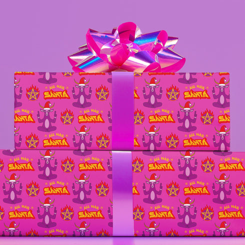 Vibrant pink wrapping paper featuring Occult symbol Baphomet Santas throwing horns, surrounded by flaming pentagrams and "All Hail Santa" text. A punk rock twist on Christmas gift wrap.