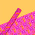Vibrant pink wrapping paper featuring Occult symbol Baphomet Santas throwing horns, surrounded by flaming pentagrams and "All Hail Santa" text. A punk rock twist on Christmas gift wrap.