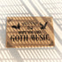 Tan coir doormat featuring "Welcome, Hope You Like Goth Music" in black text, with bat and skull imagery and gothic-style corner decorations.