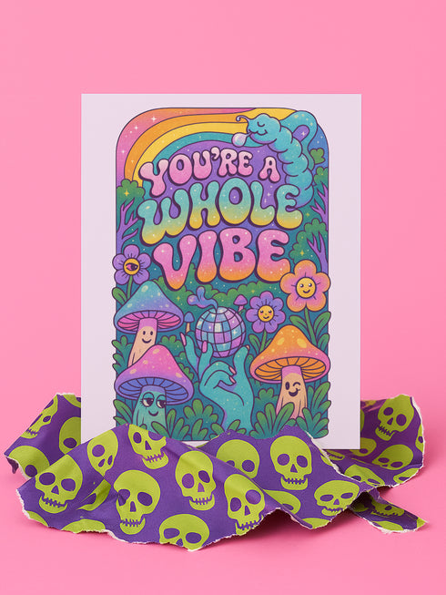 5x7 inch greeting card featuring colorful psychedelic artwork with smiling mushrooms, pastel rainbow, disco ball, flowers, and a blue slug. The inside reads: “Keep blooming, keep weirding. You’re exactly the kind of strange this world needs.” Printed on silk cover stock with a soft glossy finish and includes a white envelope