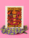 5x7 inch birthday greeting card featuring a bold psychedelic design with a snake wrapped around a melting candle, flames, mushrooms, and planets in red, orange, and pink tones. The card includes a white envelope and an interior message that reads, "One more year of burning brighter and giving zero f*cks." Printed on glossy silk stock.